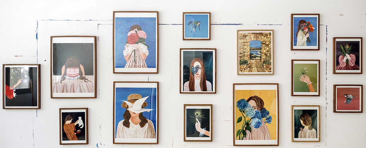 A collection of Elleny Gherghe fine art prints displayed in frames on a wall